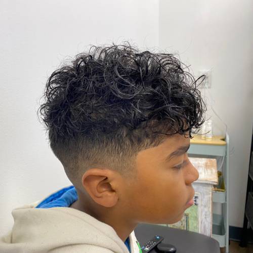 Curly textured haircut and fade by Meagen Rose